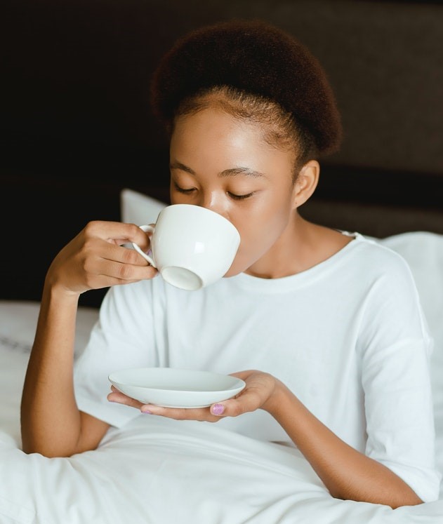 Woman having tea in bed
