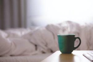 Cup of tea by a bed
